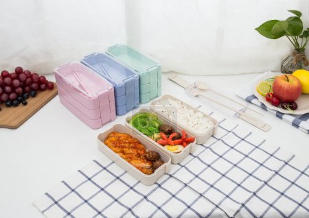 Photo for Colored plastic lunchboxes on the table - Royalty Free Image