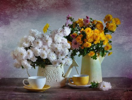 Beautiful flowers in a jug and cup of tea