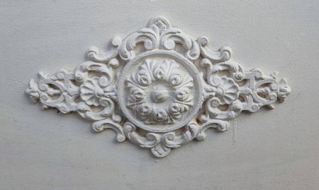 vintage and decorative floral molding on white wall in the city