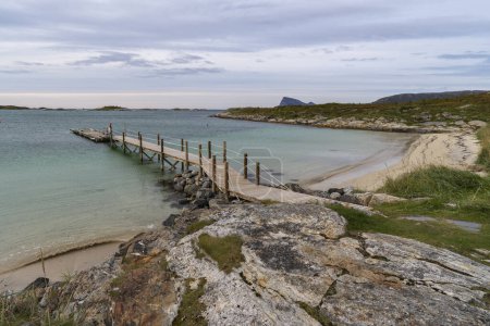 panoramic view with Jetty on the Atlantic near Sommary, Norway. Sandy beach with barbecue area and relaxation area, by the turquoise sea, surrounded by flowers and bushes. like in the Caribbean! relaxing outdoor in northern wilderness
