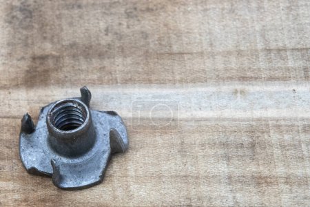 Photo for T nut, tee nut, blind nut, flush fitting, pronged nut, used to mount materials to a work piece leaving a flush surface, woodworking, joint - Royalty Free Image