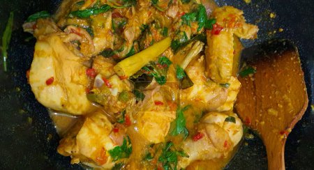 Ayam woku is a traditional dish from the Minahasa or Manado region of Indonesia, made of a chicken cooked mix of herbs and spices, ingredients are lemongrass, turmeric, kaffir lime leaves, and chili pepper home made cooking
