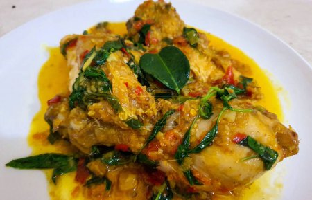 Ayam woku is a traditional dish from the Minahasa or Manado region of Indonesia, made of a chicken cooked mix of herbs and spices, ingredients are lemongrass, turmeric, kaffir lime leaves, and chili pepper home made cooking