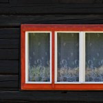 Window and facing of vintage cottage on countryside. 