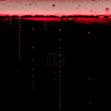 Photo for Vanishing bubbles in sparkling fizzy red vine drink. Close up detail. - Royalty Free Image
