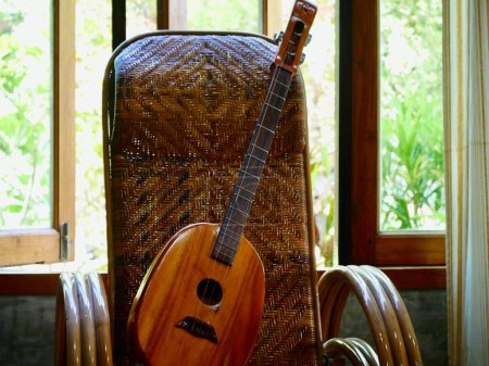 Téléchargez les photos : Gros plan de l'art de la mandoline, Mandoline style plat isolé sur blanc. instrument de musique objet concept, guitare sur le canapé - en image libre de droit