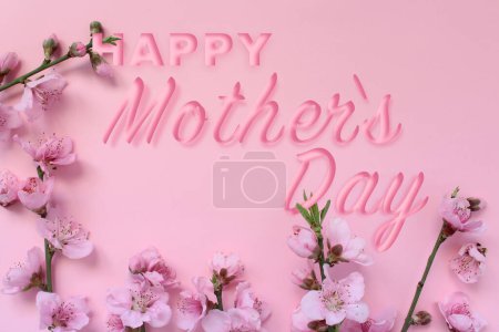 Foto de Concepto del Día de la Madre. Rama del árbol de flores y texto 'Feliz Día de la Madre' aislado sobre fondo rosa. - Imagen libre de derechos