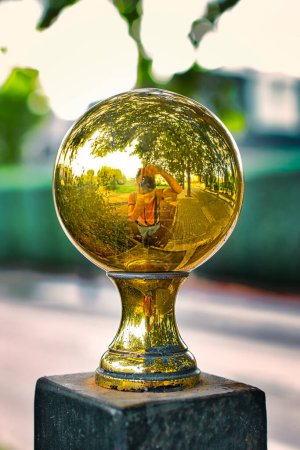 Photo for Deformed image of the photographer on a polished metal ball. - Royalty Free Image