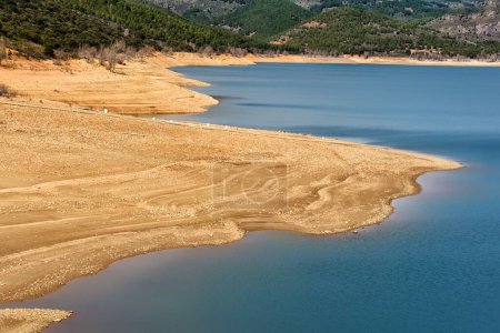 Banks of the Belena de Sorbe reservoir, Guadalajara (Spain), with low water level due to drought.