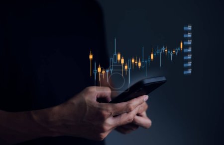 Concept of investment management. strategy finance success wealth. A businessman's or trader's hand is showing a growing virtual hologram stock on a smartphone, indicating an investment in trading.