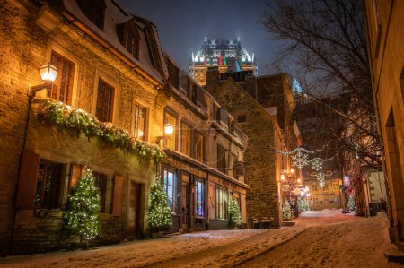 Foto de Sous-le-Fort Street en Petit-Champlain District en el casco antiguo de Quebec, iluminado con decoraciones navideñas de invierno, Fairmont Chateau Frontenac hotel, Quebec City, Canadá diciembre 2022. - Imagen libre de derechos