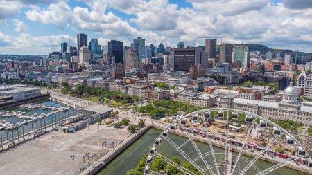 Vue aérienne panoramique du quartier financier du centre-ville de Montréal et du vieux port historique lors d'une journée d'été, montagne du Mont-Royal en toile de fond, Québec, Canada. Photo prise par drone en août 2021.
