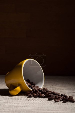 Photo for Mug with scattered coffee beans on burlap. - Royalty Free Image