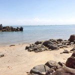 The Tropical Beach Of Tanjung Kalian In The Hot Sun With Rock Formations