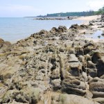 Natural View Of A Tropical Beach In Summer With Rocks Arranged Along The Coastline Of Tanjung Kalian, Indonesia