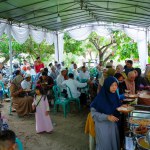 MUNTOK,INDONESIA - APRIL 17, 2023 : A Crowd Of People Under A Tent, At A Family Event With Buffet Food