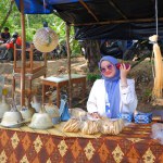 MUNTOK,INDONESIA - SEPTEMBER 10, 2023 : A Muslim Woman Who Is Guarding A Souvenir Table Outdoors, At A Traditional Villagerambat Party