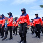 MUNTOK,INDONESIA - SEPTEMBER 10, 2023 : Women Marching March Participants In Orange And Black Costumes, During The Indonesian Independence Day Celebration