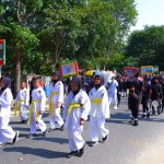 MUNTOK,INDONESIA - SEPTEMBER 10, 2023 : Carnival Participants, Elementary School Students In Pencak Silat Uniforms, During The Celebration Of Indonesian Independence Day