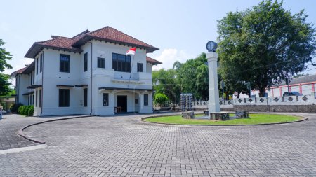 Ancien bâtiment du musée de l'étain avec une grande cour et un monument, dans la ville de Muntok, Indonésie