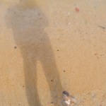 A Shadow Of A Man In The Sand Of Tanjung Kalian Beach, Indonesia