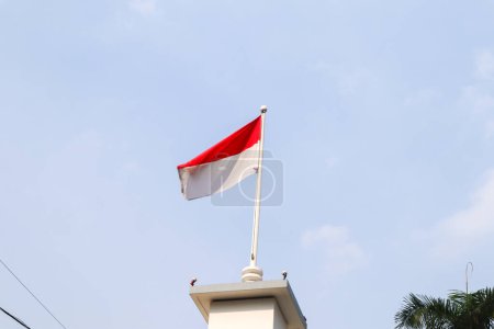 indonesia flag with sky background above majapahit hotel, surabaya