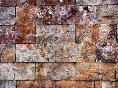 Foto de Textura de piedra roja en ladrillo de muro en Las Palmas de Gran Canaria. Espana 2023 - Imagen libre de derechos