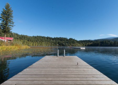 a wooden pier surrounded by a calm lake