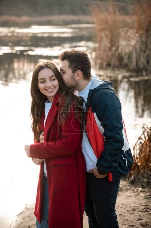 young loving man and woman in autumn park.Romantic date.Man and woman.Love of two people.Family in nature.Real relationship.Happy family.Real couple of lovers.The couple hugs in nature.Photo for valentine's day.Valentine's day.Romance.newlyweds.walk.