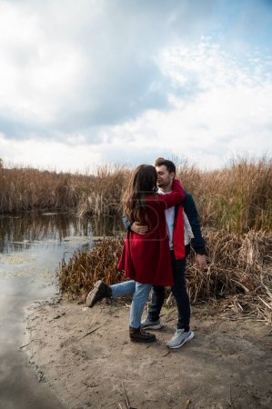 couple in love on the lake.Romantic date.Man and woman.Love of two people.Family in nature.Real relationship.Happy family.Real couple of lovers.The couple hugs in nature.Photo for valentine's day.Valentine's day.Romance.newlyweds.walk in nature