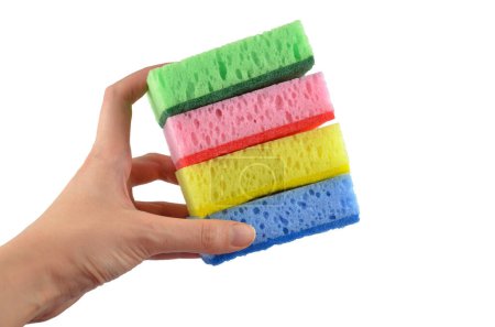 Foto de Una pila de esponjas de lavado (amarillo, rosa verde y azul) en una mano aislada - Imagen libre de derechos
