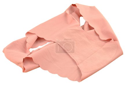 Gusset, peach pink seamless (invisible) women's underwear (lingerie, panties, briefs) with wavy edge isolated, inner part closeup