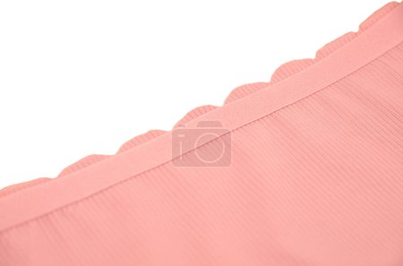 Peach pink seamless (invisible) women's underwear (lingerie, panties, briefs) with wavy edge isolated, rubber band closeup