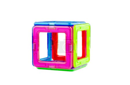 A cube made of colorful transparent magnet squares (puzzle builder for kids), closeup isolated on a white background