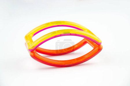 Curved colorful transparent magnet shapes (puzzle builder for kids) isolated on a white background
