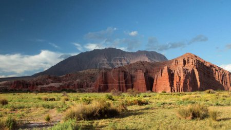 Photo for Idyllic landscape. Panorama view of the red sandstone and rock formation called The castles, in Salta, Argentina. The valley, grassland and mountains at sunset. - Royalty Free Image