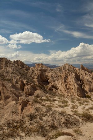 Photo for Vertical photo. Arid landscape. Geology. View of the dry valley, sandstone and rocky hills. - Royalty Free Image