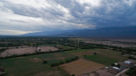 Photo for Aerial view of fields and scenic mountains at cloudy day - Royalty Free Image