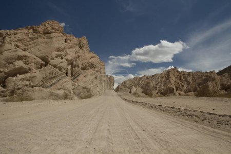 Traveling along Route 40. Dirt road across the arid desert and sandstone, in Quebrada de las Flechas, Salta, Argentina. 