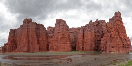 Photo for The canyon red cliffs and lake. Panorama view of the popular red sandstone and rocky formation called The Castles  in Salta, Argentina. - Royalty Free Image