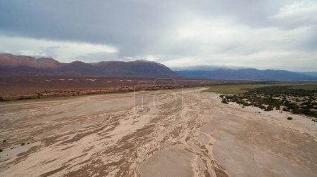 Téléchargez les photos : Textures naturelles. Vue aérienne du désert aride, du sable, des dunes et des montagnes sous un ciel nuageux. - en image libre de droit