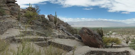 Photo for Ancient fortress. Archaeological site. Panorama view of the city ruins of the Quilmes aboriginal civilization with Inca influence. Structures made of stone very high in the mountains. - Royalty Free Image