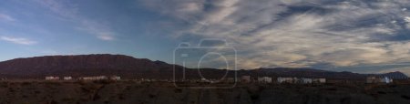 Photo for Culture and religion. Panorama view of an aboriginal cemetery very high in the mountains.The graveyard and tombs in the mountain summit at nightfall. - Royalty Free Image