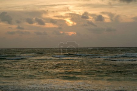 Foto de Verano. El mar y las olas del océano al amanecer. Colores del amanecer en la superficie del agua, cielo y nubes. - Imagen libre de derechos