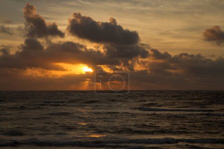 Photo for Vacations. Seascape. Dramatic view of the sky, clouds, ocean and sea waves at sunset. Beautiful golden colors. - Royalty Free Image