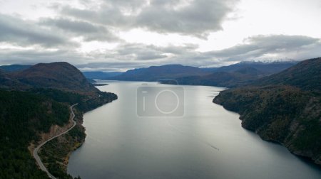 Photo for The lake at sunset. Aerial view of the lake, forest, mountains, and road at nightfall. - Royalty Free Image