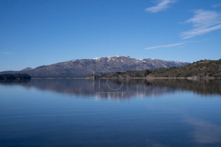 Photo for The lake in a sunny morning. Panorama view of the forest, lake and the perfect reflection of the sky in the blue water. The Andes mountain range in the background. - Royalty Free Image