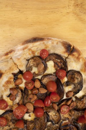 Photo for Top view of a pizza with mozzarella cheese, cherry tomatoes and roasted eggplant. - Royalty Free Image