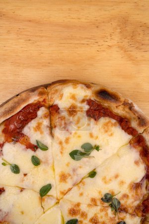 Photo for Traditional mozzarella cheese pizza with tomato sauce, fresh oregano leaves and olive oil. - Royalty Free Image
