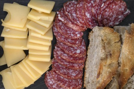 Antipasto. Top view of a dish with sliced salami, cheese and bread.